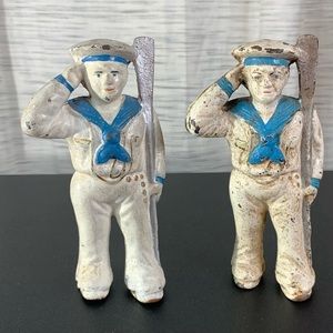 A pair of Hubley cast-iron Saluting Sailor Oarsman coin banks.